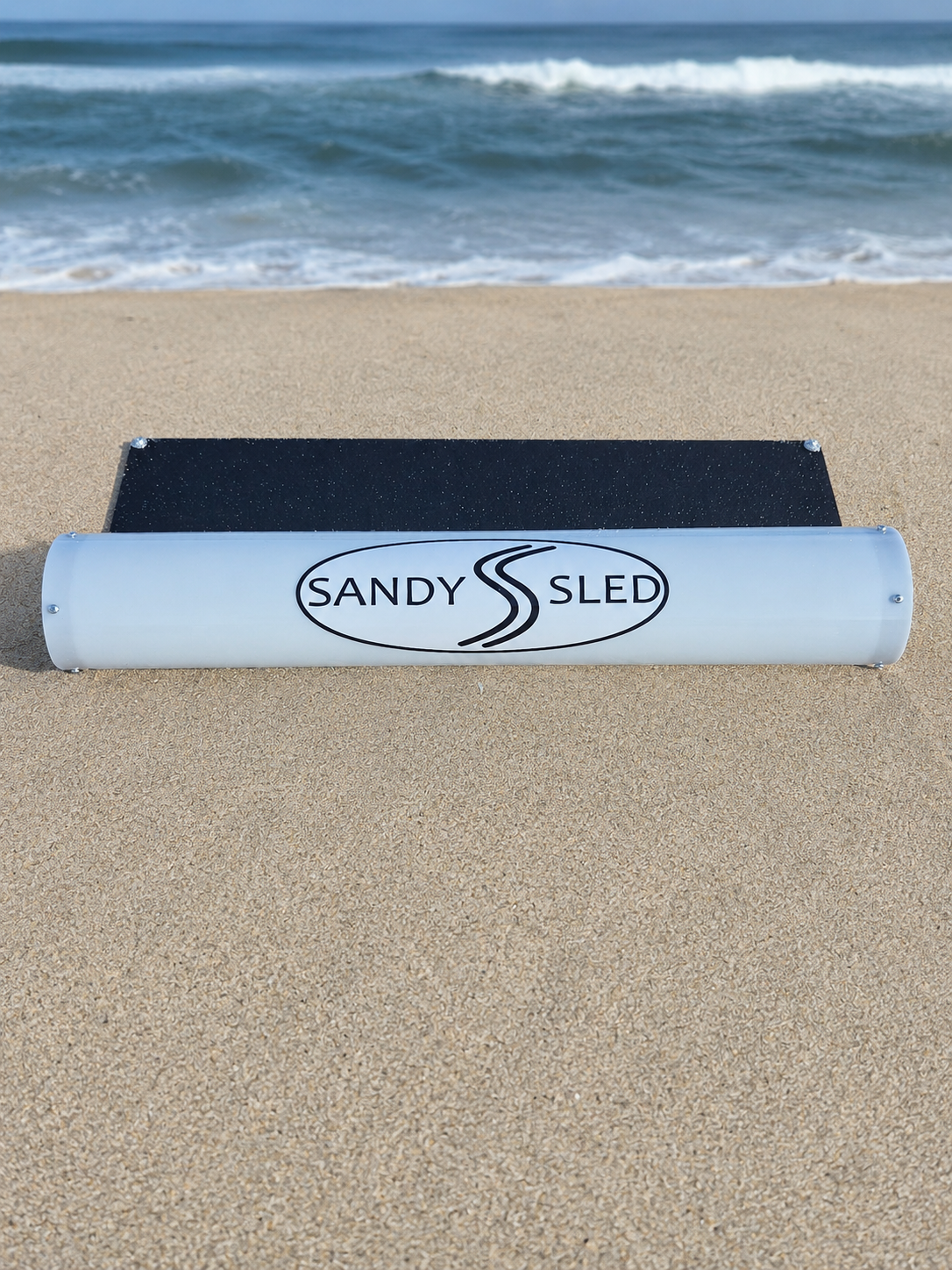 SandySled product shown flat on soft beach sand